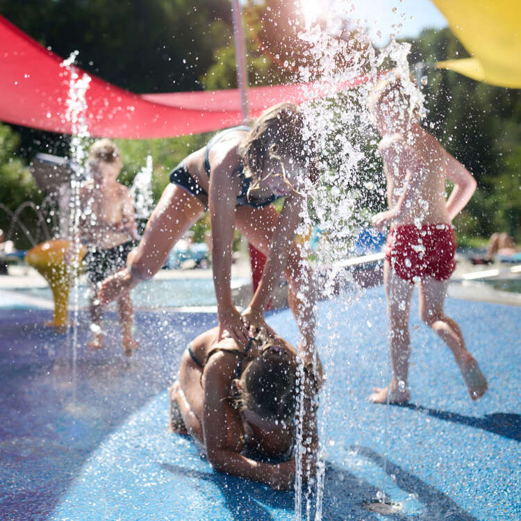 Kinder toben im Kinderbecken des Außenbereichs im Aquaria Oberstaufen